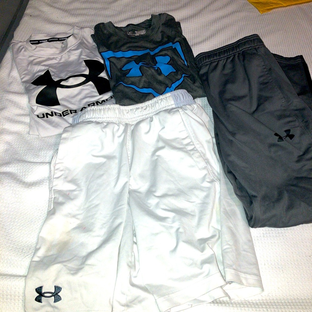 Lot of 4 under Armour size YMD/JM/M 2 shirts, 1 short, 1 sweatpants